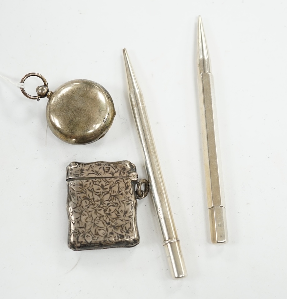 A George V silver sovereign case, a silver vesta case and two silver propelling pencils. Condition - poor to fair